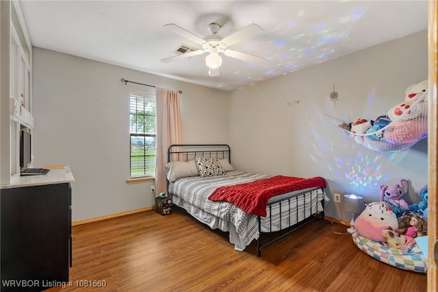 103 Bowlin Dr, Poteau, OK 74953 - bedroom with wood finished floors and ceiling fan