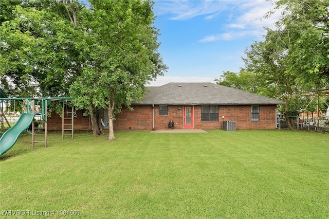 103 Bowlin Dr, Poteau, OK 74953 - back of house with a playground, a patio area, brick siding, and roof with shingles