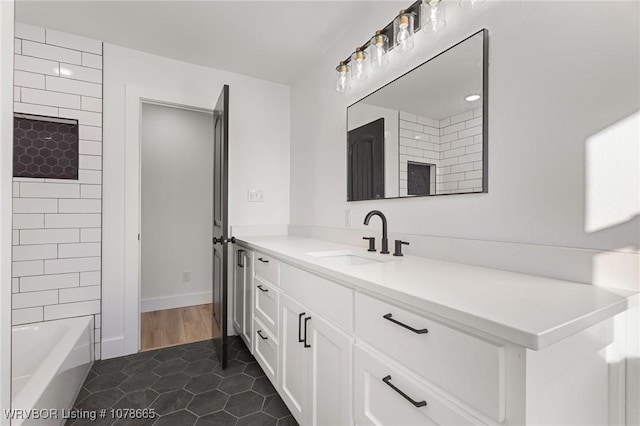 bathroom with tile patterned flooring, vanity, and tiled shower / bath combo