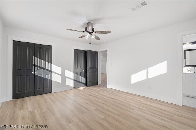 unfurnished room with sink, light hardwood / wood-style flooring, and ceiling fan