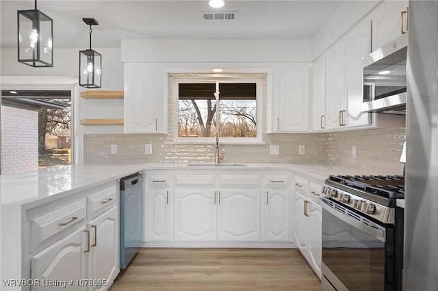 kitchen featuring white cabinetry, sink, light wood-type flooring, and appliances with stainless steel finishes