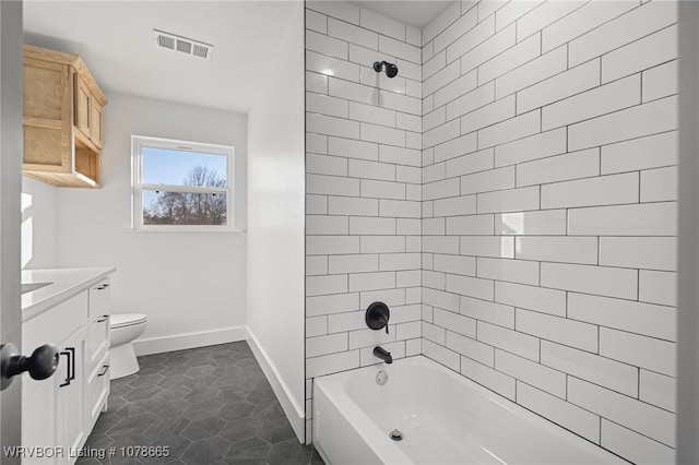 full bathroom with tile patterned flooring, vanity, toilet, and tiled shower / bath