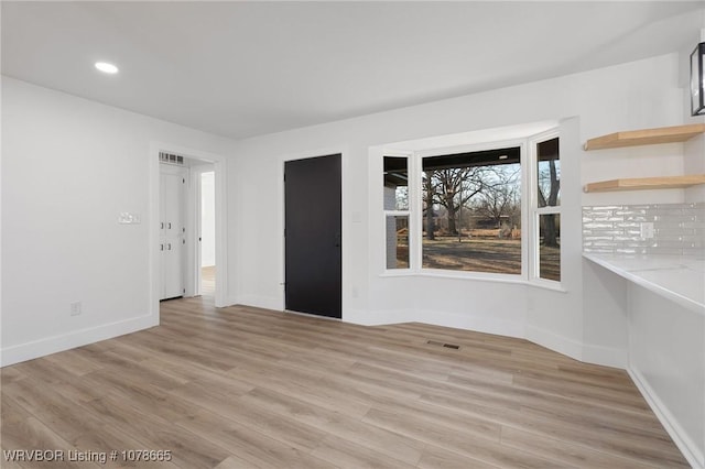 spare room with light hardwood / wood-style flooring