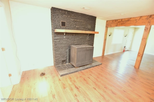 98926 S 4610th Rd, Marble City, OK 74945 - unfurnished living room featuring wood finished floors and a wood stove