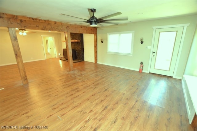 98926 S 4610th Rd, Marble City, OK 74945 - unfurnished living room with a ceiling fan, a fireplace, wood finished floors, and baseboards