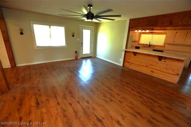98926 S 4610th Rd, Marble City, OK 74945 - unfurnished living room featuring a sink, dark wood-style floors, baseboards, and a ceiling fan