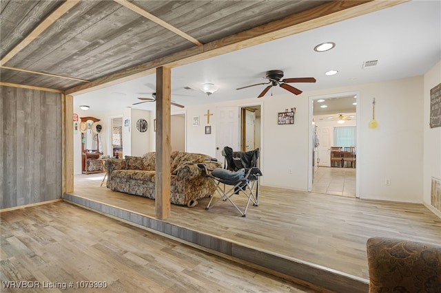 interior space featuring baseboards, visible vents, and wood finished floors