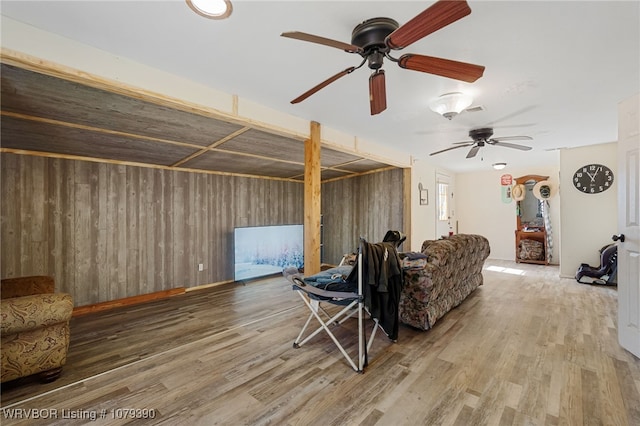 living room featuring wood finished floors and wooden walls