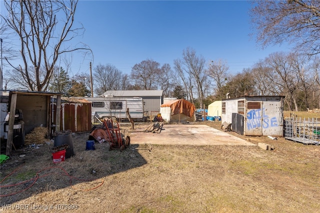 view of yard with a storage shed, fence, and an outdoor structure