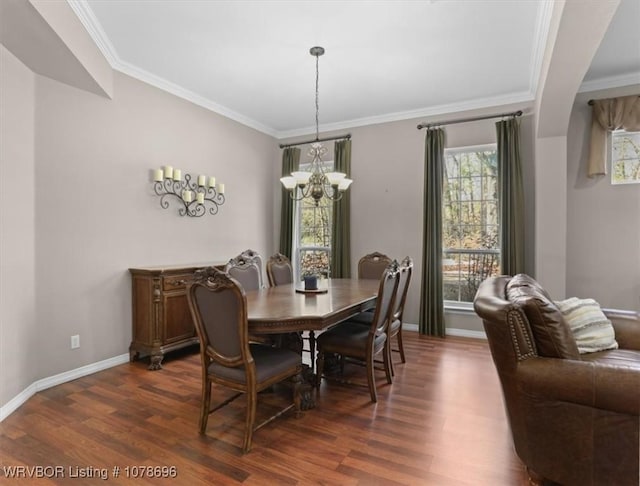 dining room with ornamental molding, dark hardwood / wood-style floors, and a chandelier