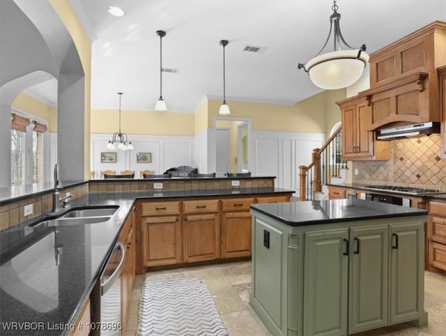 kitchen featuring hanging light fixtures, sink, kitchen peninsula, and stainless steel gas cooktop