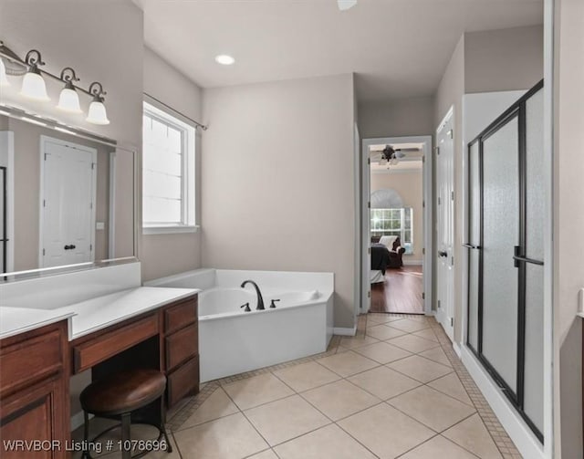 bathroom with vanity, tile patterned floors, and plus walk in shower