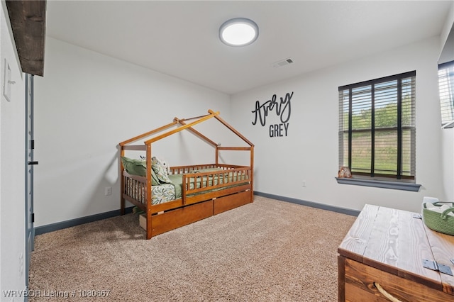 bedroom featuring baseboards, visible vents, and carpet
