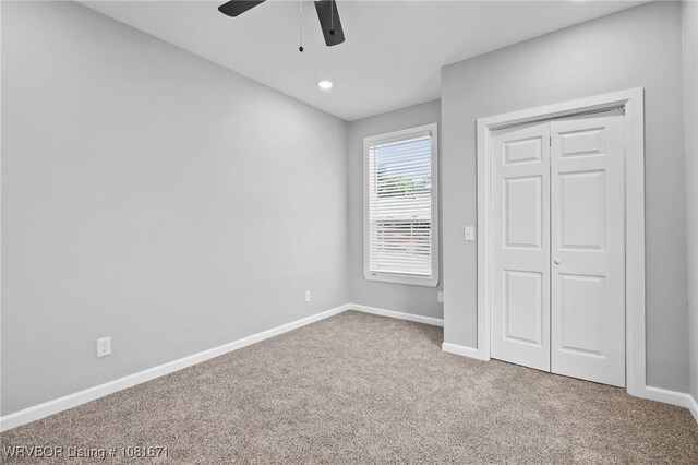 179 E Grove St, Magazine, AR 72943 - unfurnished bedroom featuring carpet, a closet, and ceiling fan
