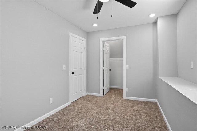 179 E Grove St, Magazine, AR 72943 - unfurnished bedroom featuring carpet flooring, a spacious closet, recessed lighting, a ceiling fan, and a closet