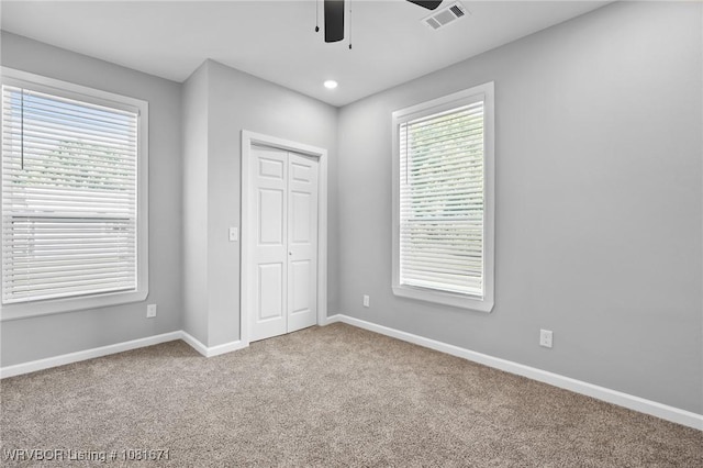 179 E Grove St, Magazine, AR 72943 - unfurnished bedroom with carpet flooring, a closet, recessed lighting, and a ceiling fan