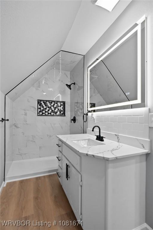 179 E Grove St, Magazine, AR 72943 - bathroom with vanity, a shower, and wood finished floors