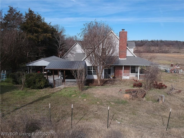 view of front of house with covered porch and a front yard