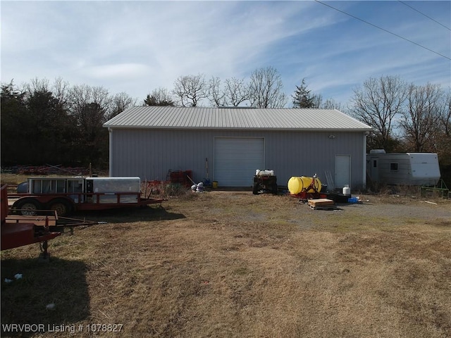 exterior space featuring a garage and a lawn