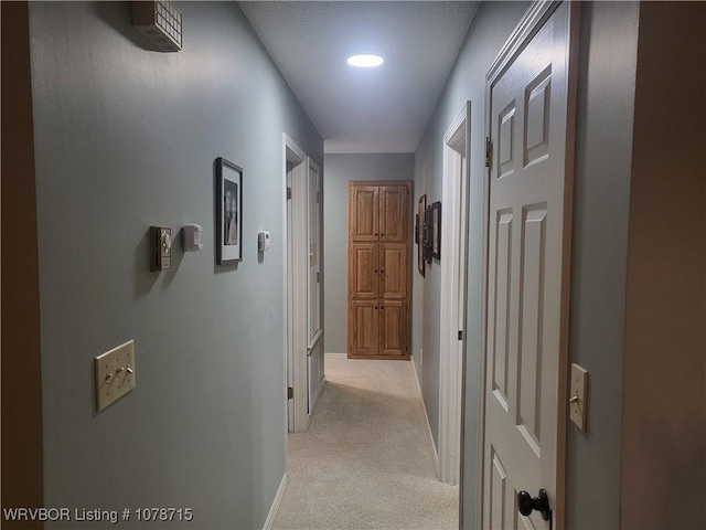 corridor featuring light colored carpet