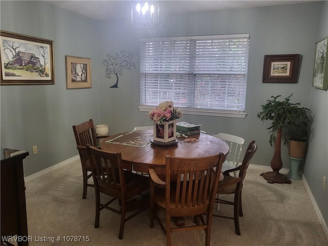 dining area featuring light carpet