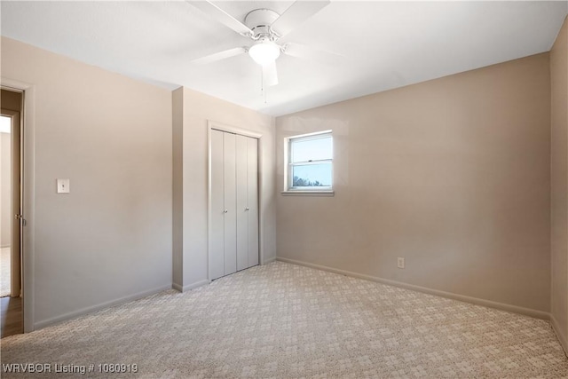 unfurnished bedroom featuring carpet, a closet, baseboards, and a ceiling fan