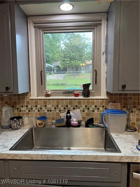 2303 Willow St, Van Buren, AR 72956 - kitchen with gray cabinetry, light countertops, tasteful backsplash, and a sink