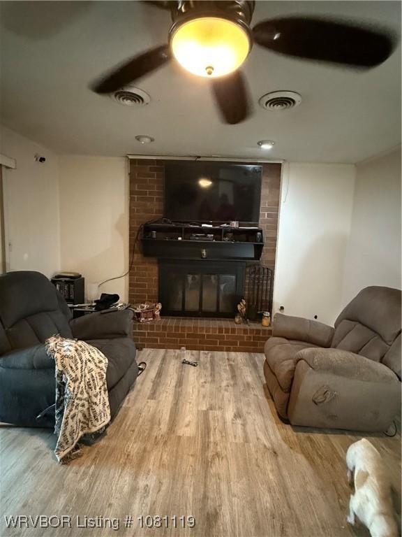 2303 Willow St, Van Buren, AR 72956 - living area with a brick fireplace and wood finished floors