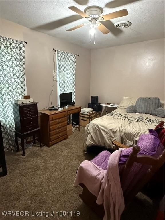 2303 Willow St, Van Buren, AR 72956 - carpeted bedroom with a textured ceiling, an office area, and ceiling fan