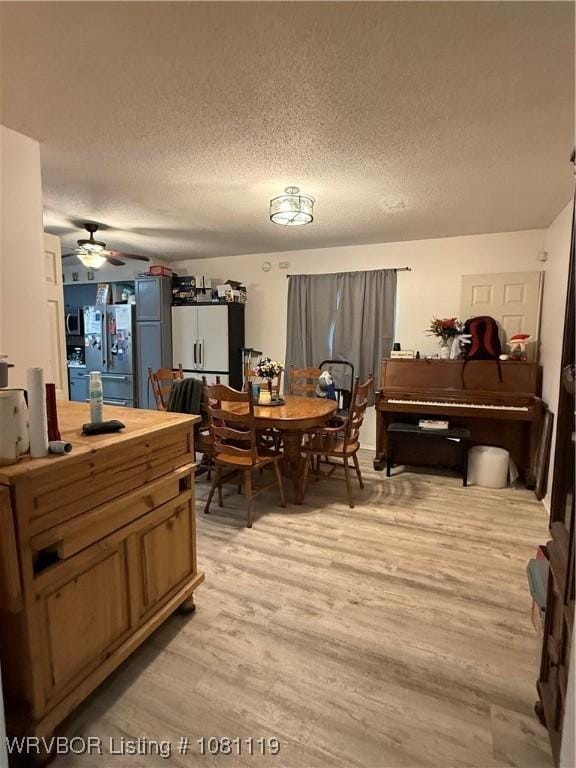 2303 Willow St, Van Buren, AR 72956 - dining space with light wood-type flooring, ceiling fan, and a textured ceiling