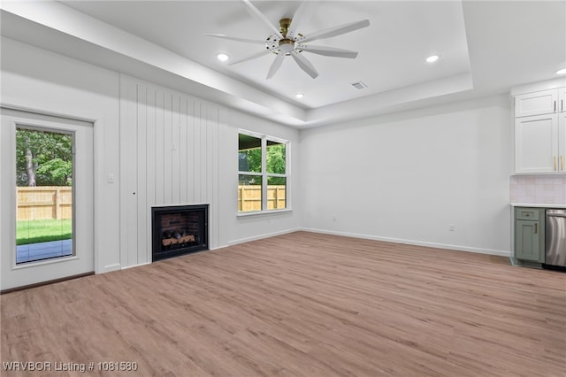 9005 Carson Way, Fort Smith, AR 72908 - unfurnished living room with plenty of natural light, light wood-type flooring, a raised ceiling, and recessed lighting