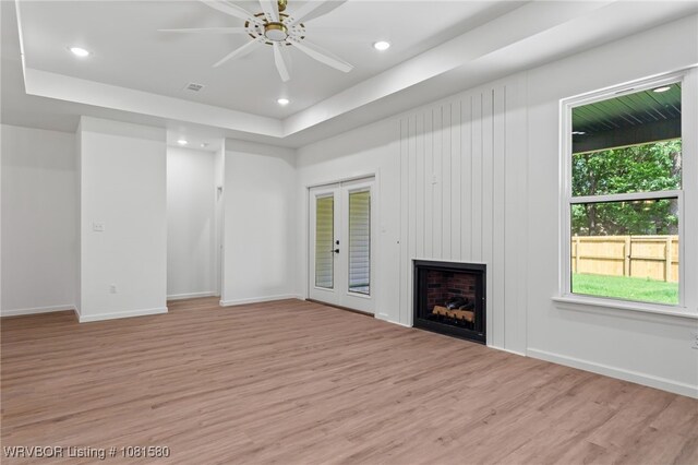 9005 Carson Way, Fort Smith, AR 72908 - unfurnished living room with light wood finished floors, a large fireplace, recessed lighting, a ceiling fan, and a raised ceiling