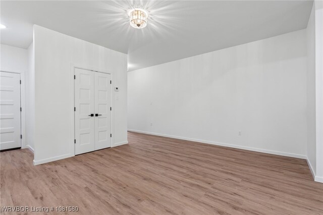9005 Carson Way, Fort Smith, AR 72908 - empty room with light wood-type flooring, baseboards, and a chandelier