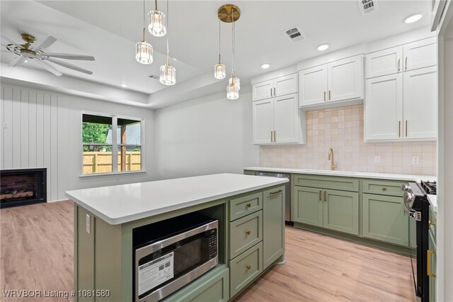 9005 Carson Way, Fort Smith, AR 72908 - kitchen with green cabinetry, stainless steel appliances, a sink, light wood-style flooring, and recessed lighting