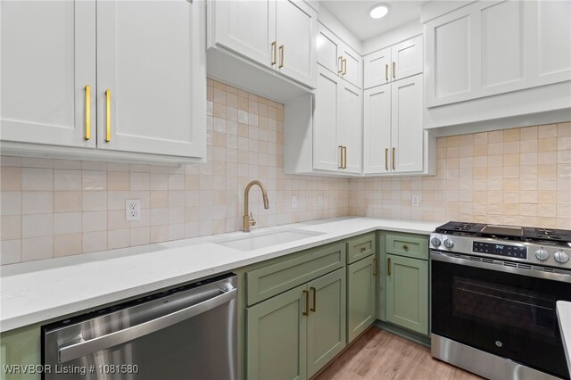 9005 Carson Way, Fort Smith, AR 72908 - kitchen featuring stainless steel appliances, green cabinetry, a sink, white cabinetry, and light wood-type flooring