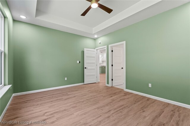 9005 Carson Way, Fort Smith, AR 72908 - unfurnished bedroom featuring a raised ceiling, light wood-style floors, recessed lighting, and baseboards