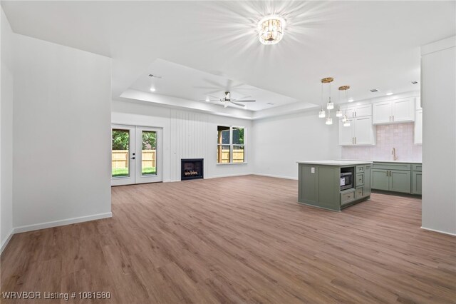 9005 Carson Way, Fort Smith, AR 72908 - unfurnished living room with a raised ceiling, ceiling fan, light wood finished floors, baseboards, and recessed lighting