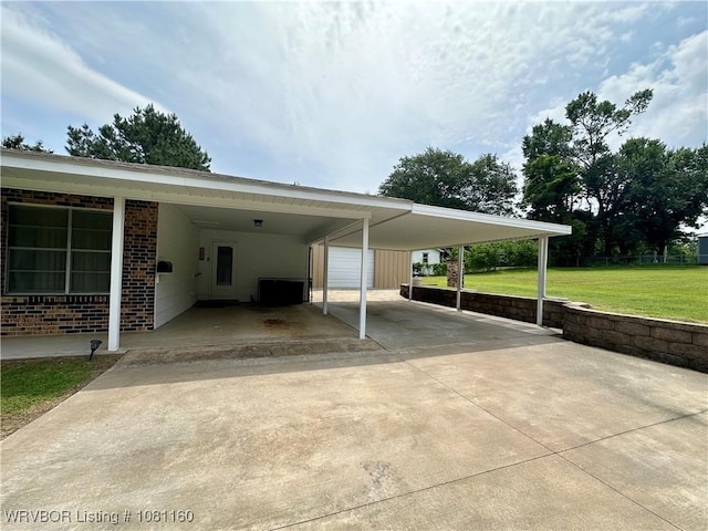 105 7th St, Paris, AR 72855 - view of parking / parking lot with an attached carport and concrete driveway