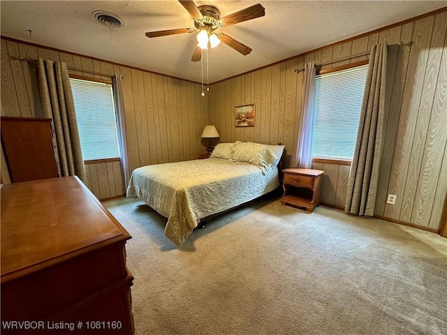 105 7th St, Paris, AR 72855 - bedroom with wooden walls, a textured ceiling, carpet floors, a ceiling fan, and ornamental molding