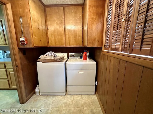 105 7th St, Paris, AR 72855 - laundry area with cabinet space, washer and clothes dryer, and wooden walls