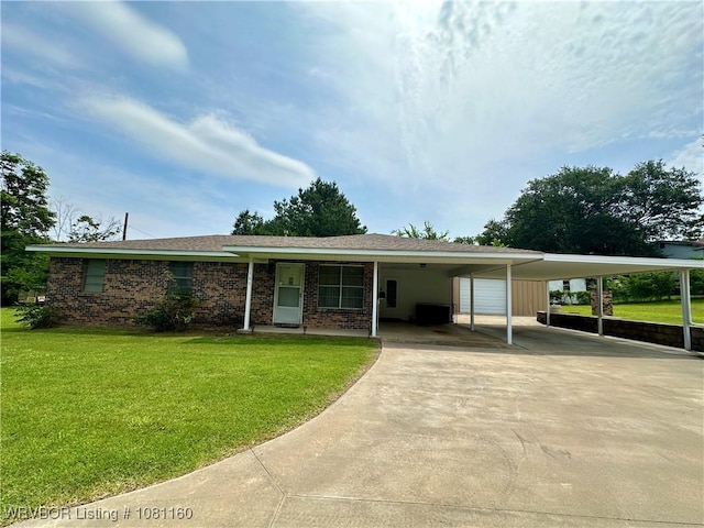 105 7th St, Paris, AR 72855 - view of front of house featuring an attached carport, concrete driveway, a front lawn, and brick siding