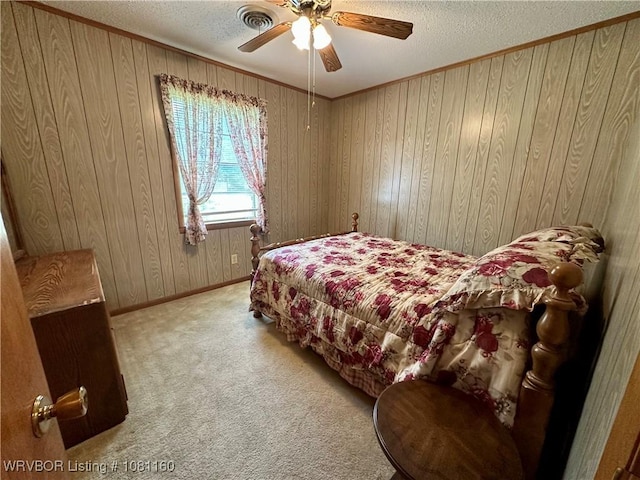 105 7th St, Paris, AR 72855 - bedroom featuring a textured ceiling, wood walls, carpet, ceiling fan, and ornamental molding