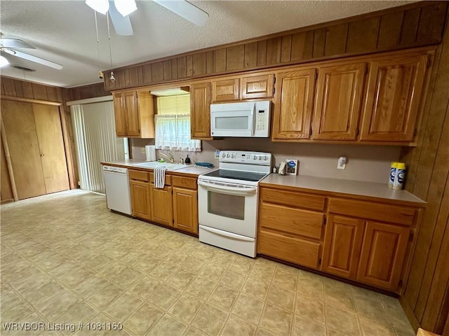 105 7th St, Paris, AR 72855 - kitchen featuring white appliances, ceiling fan, light countertops, brown cabinets, and a textured ceiling