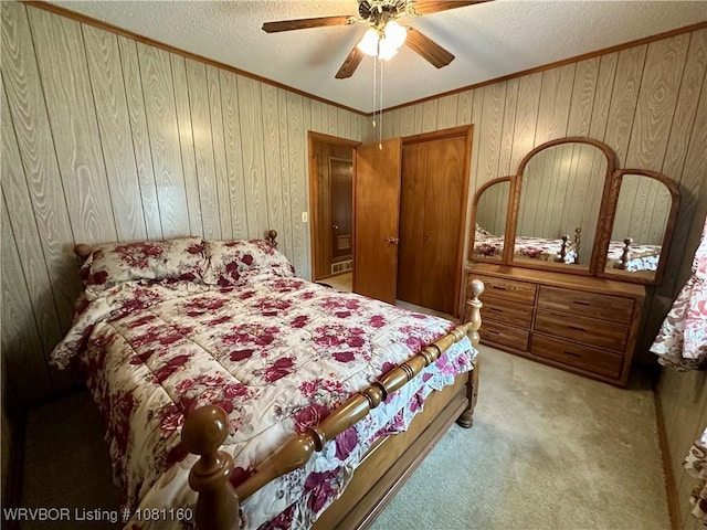 105 7th St, Paris, AR 72855 - bedroom with crown molding, a textured ceiling, carpet floors, wooden walls, and ceiling fan