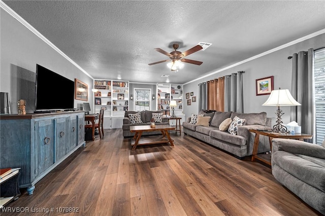 living room with a textured ceiling, ornamental molding, dark wood-type flooring, and a ceiling fan