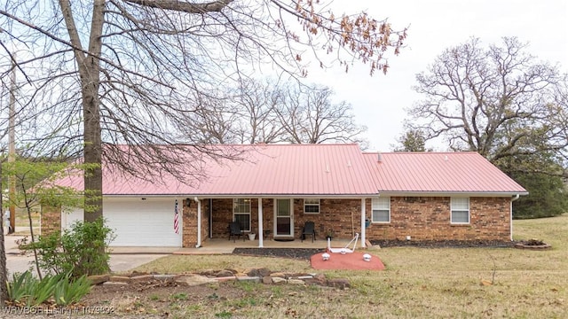 ranch-style house with brick siding, driveway, a front lawn, and an attached garage