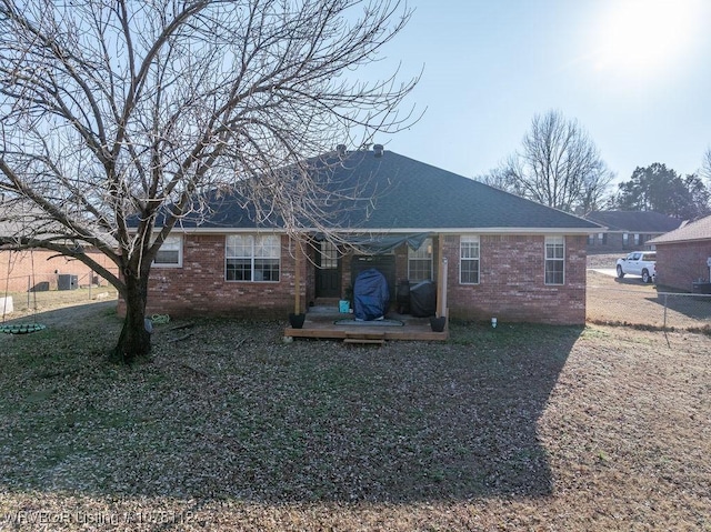 rear view of property featuring a yard