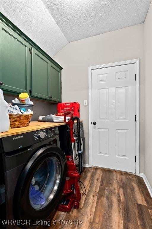 clothes washing area with dark hardwood / wood-style flooring, cabinets, a textured ceiling, and washer / clothes dryer