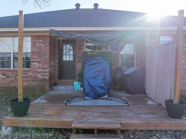 view of exterior entry featuring a wooden deck