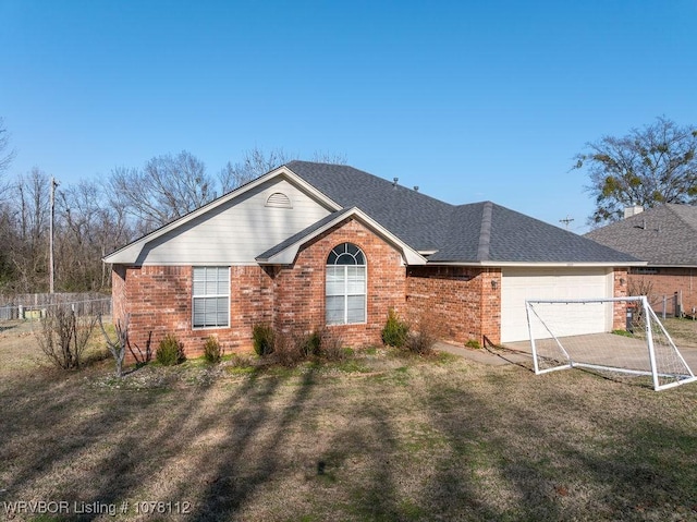 ranch-style home featuring a garage and a front lawn